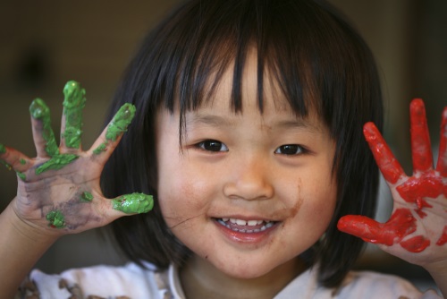 Child playing with paint at day care